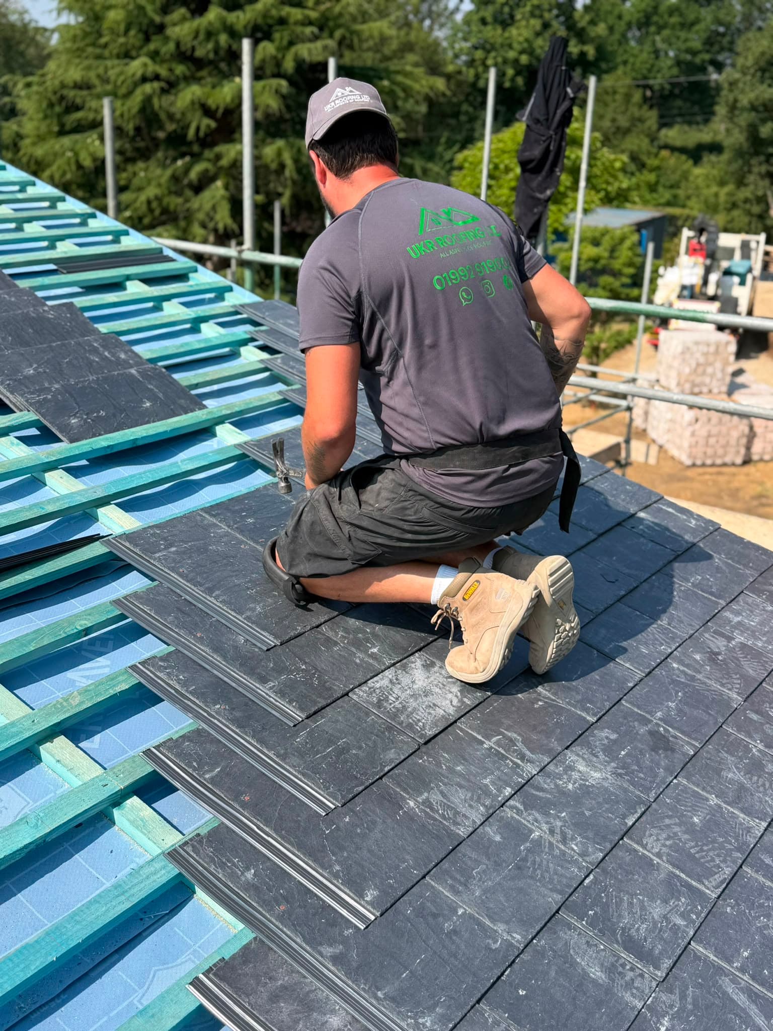 UKR Roofing specialist laying slate tiles on a pitched roof